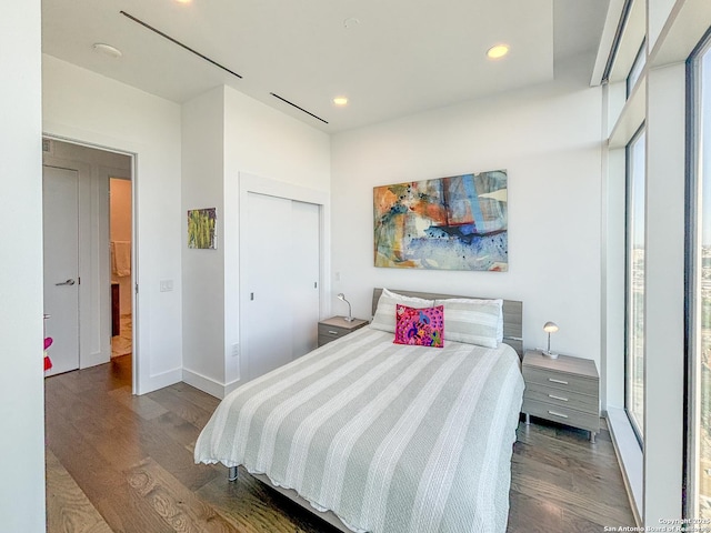 bedroom with recessed lighting, multiple windows, and wood finished floors