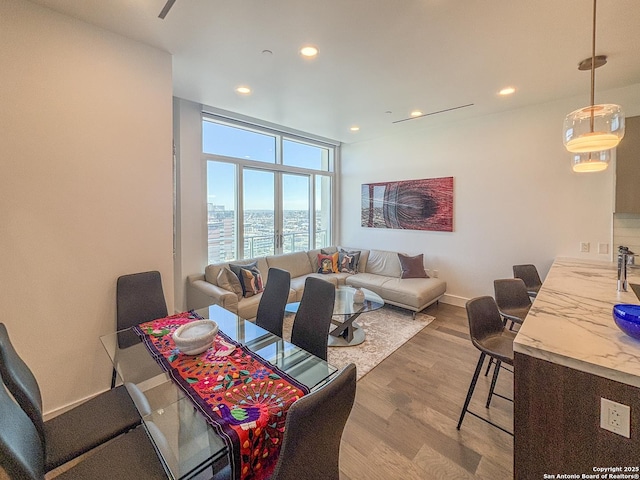 dining area with recessed lighting, baseboards, and wood finished floors