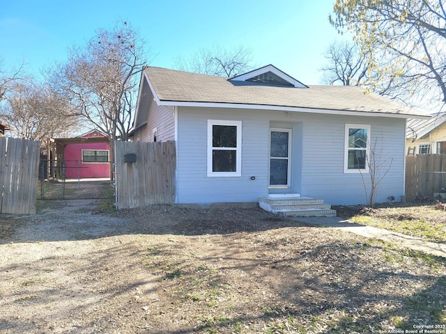 bungalow-style house featuring entry steps, a gate, and fence