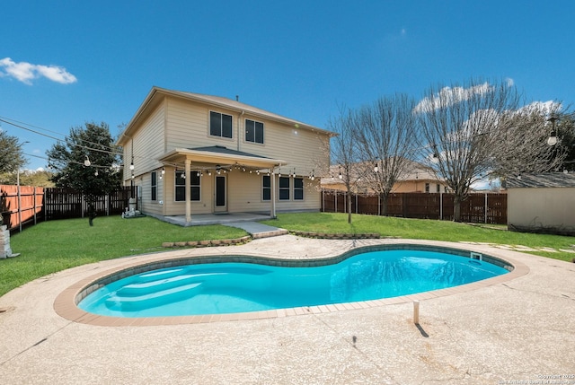 view of swimming pool featuring a yard, a patio, a fenced in pool, and a fenced backyard