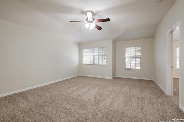 carpeted empty room featuring ceiling fan and baseboards