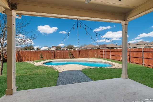 view of swimming pool with a patio, a yard, a fenced backyard, and a fenced in pool