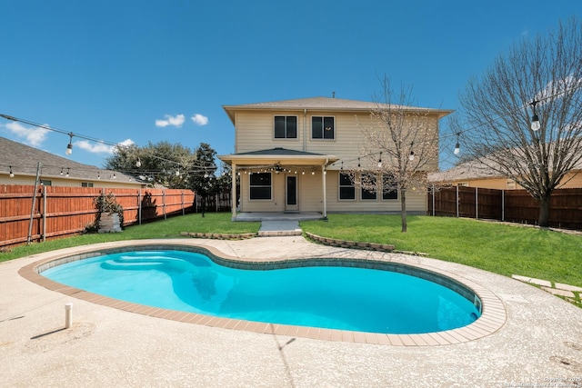 view of pool featuring a lawn, a ceiling fan, a fenced backyard, a fenced in pool, and a patio area