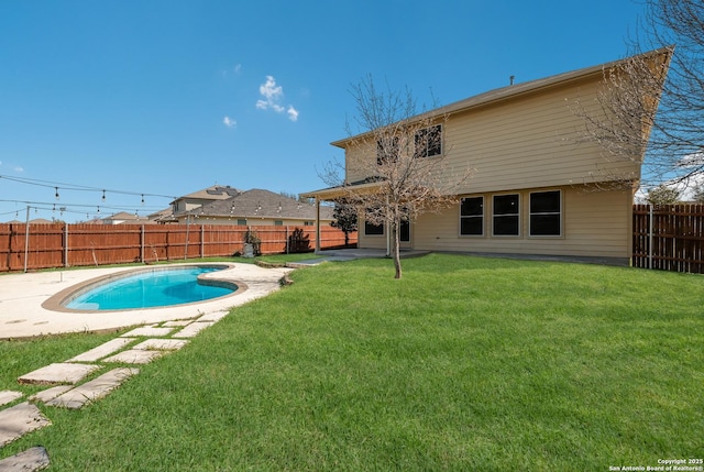 back of house with a patio, a yard, a fenced backyard, and a fenced in pool