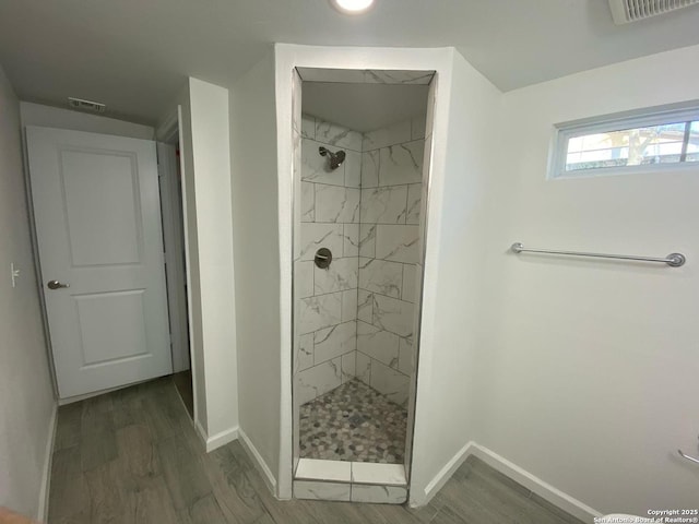 full bathroom with visible vents, a shower stall, and wood finished floors