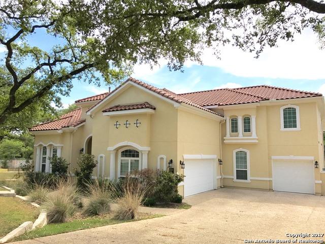 mediterranean / spanish-style home with stucco siding, concrete driveway, and a tiled roof