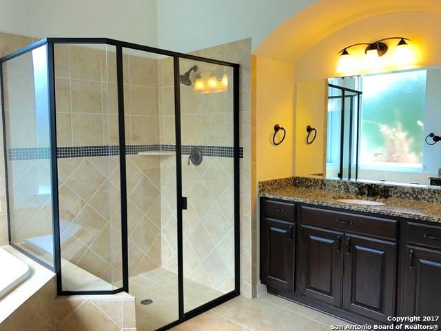 full bathroom featuring tile patterned floors, a shower stall, and vanity