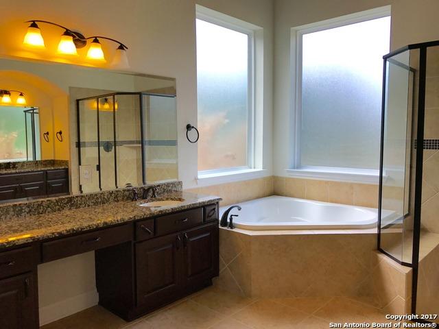 full bathroom featuring vanity, tile patterned floors, a bath, and a stall shower