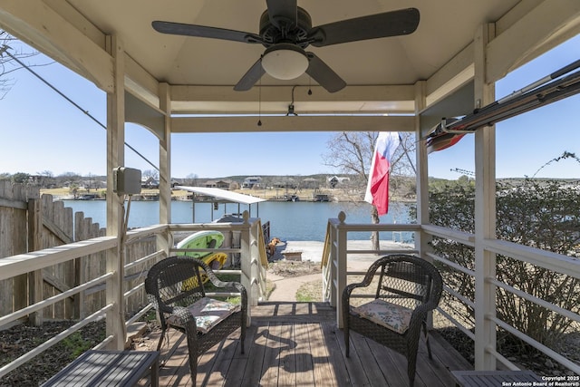 view of dock featuring fence and a water view