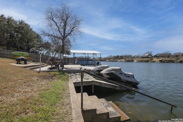 dock area featuring fence and a water view