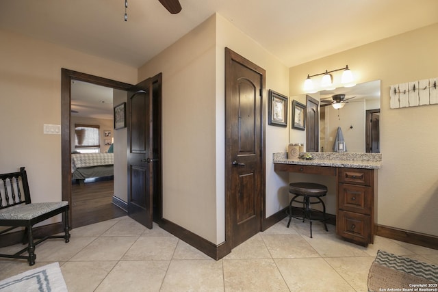 ensuite bathroom with baseboards, ensuite bath, and tile patterned flooring