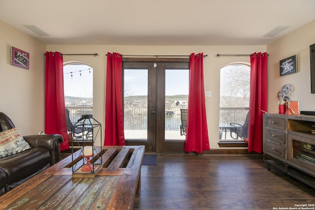 living area featuring visible vents and wood finished floors