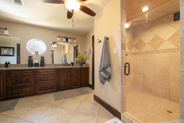 full bath featuring visible vents, a shower stall, tile patterned flooring, double vanity, and baseboards