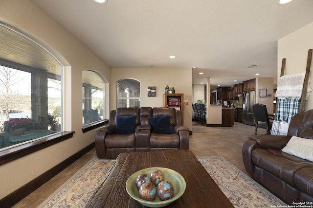 living area featuring light tile patterned floors, recessed lighting, and baseboards