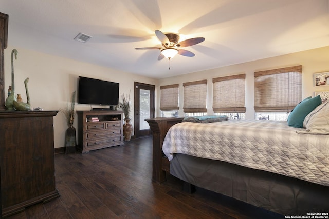 bedroom with dark wood finished floors, visible vents, a ceiling fan, and access to outside