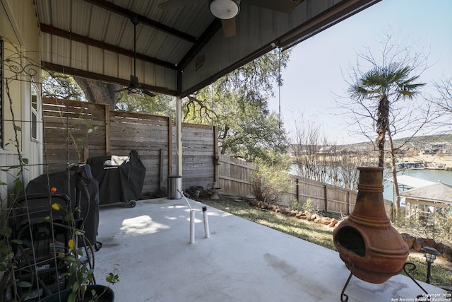 view of patio featuring a grill, a ceiling fan, and fence