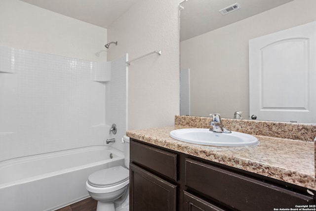 bathroom featuring visible vents, toilet, vanity, and  shower combination