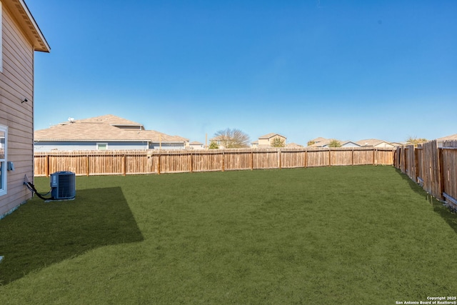 view of yard featuring central air condition unit and a fenced backyard