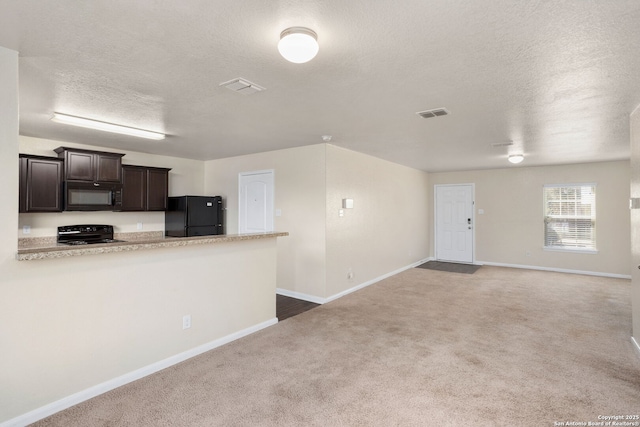 kitchen featuring visible vents, black appliances, carpet, light countertops, and dark brown cabinets