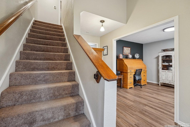 stairs featuring wood finished floors