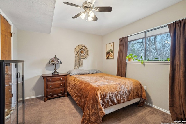 bedroom featuring a ceiling fan, carpet, baseboards, and a textured ceiling