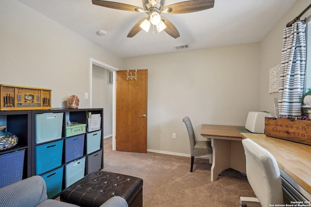 office area featuring visible vents, carpet floors, baseboards, and a ceiling fan