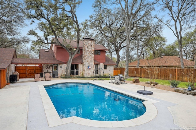 view of swimming pool featuring a patio area, a fenced in pool, and a fenced backyard