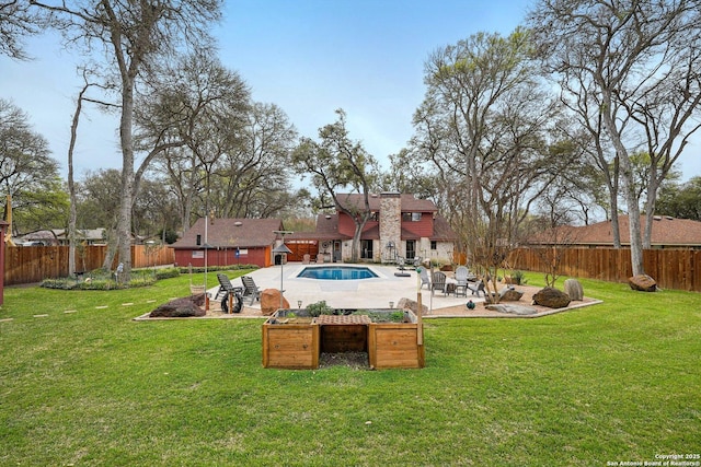 view of yard featuring a patio area, a fenced in pool, and a fenced backyard