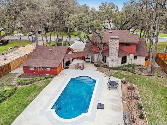 view of swimming pool featuring a fenced in pool, a patio, a lawn, and a fenced backyard