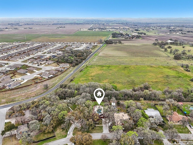 birds eye view of property with a rural view