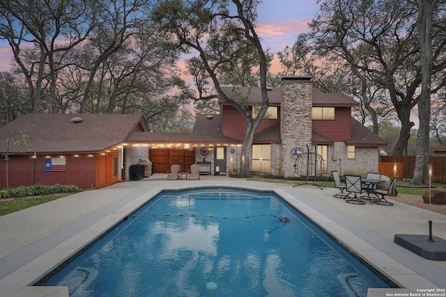 view of swimming pool with a fenced in pool, a patio, and fence