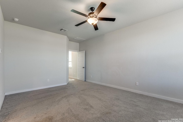 spare room with visible vents, baseboards, carpet, and a ceiling fan