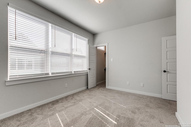 unfurnished bedroom featuring carpet flooring and baseboards