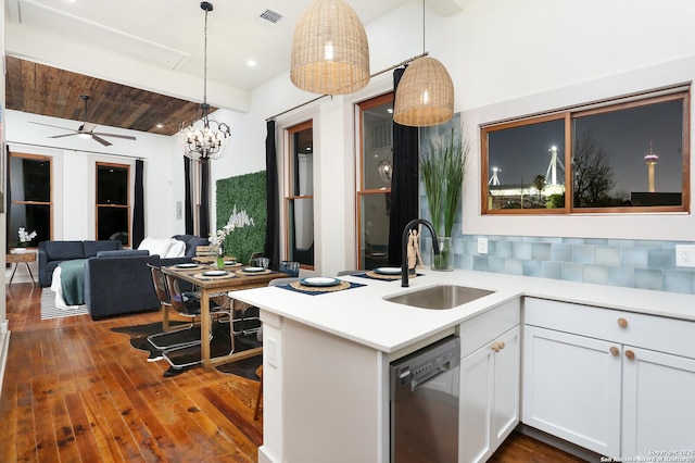 kitchen with visible vents, a sink, hanging light fixtures, light countertops, and dishwasher