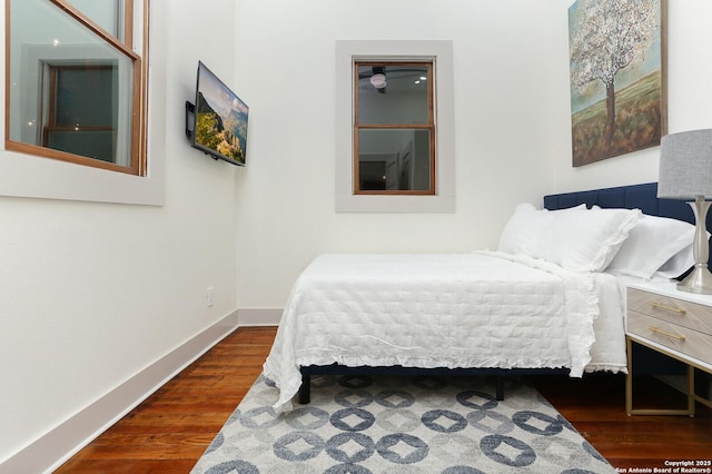 bedroom featuring baseboards and wood finished floors