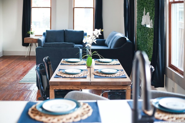 dining room with baseboards and wood finished floors