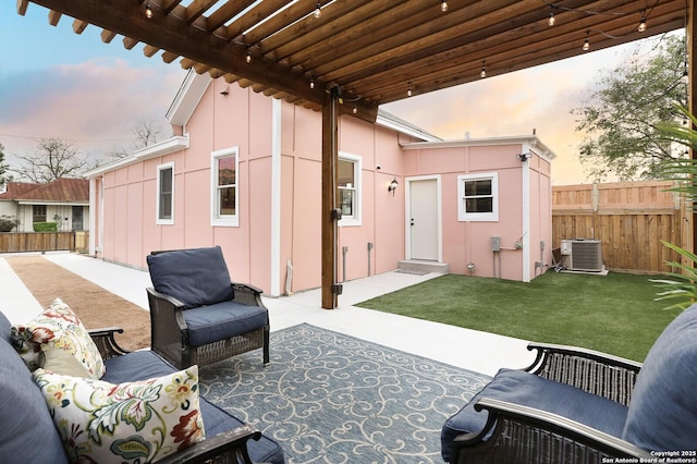 view of patio with central air condition unit and fence