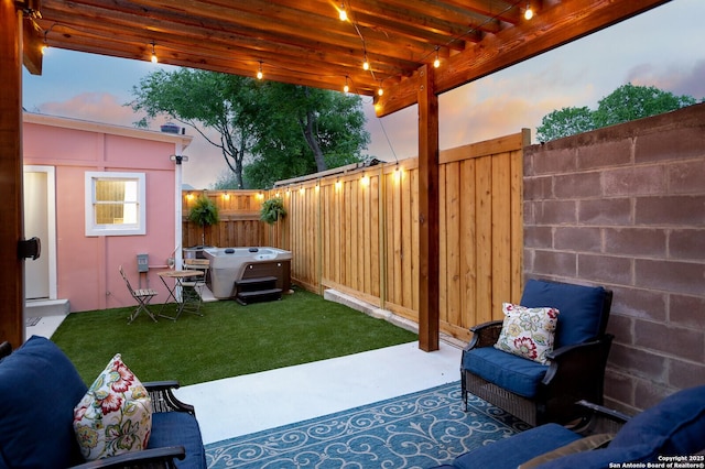 patio terrace at dusk with a fenced backyard and a lawn