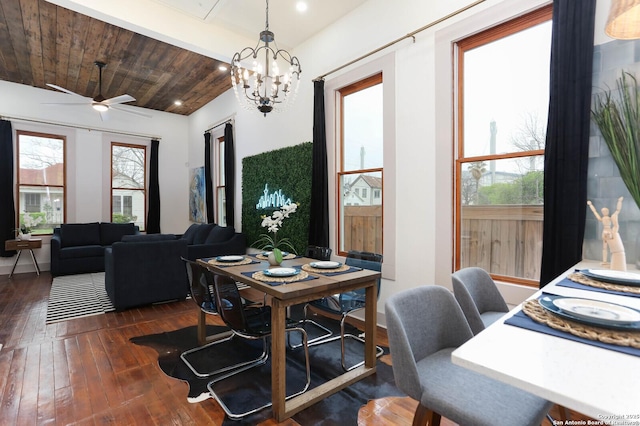 dining area with hardwood / wood-style floors, wooden ceiling, ceiling fan with notable chandelier, and a healthy amount of sunlight