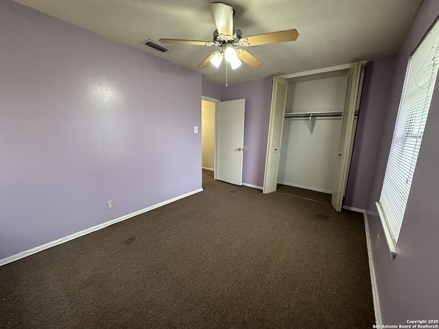 unfurnished bedroom featuring visible vents, a ceiling fan, a closet, carpet flooring, and baseboards