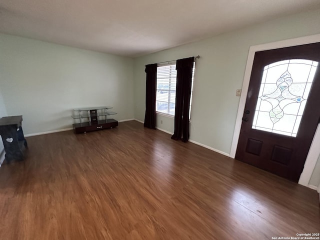 foyer entrance with wood finished floors and baseboards