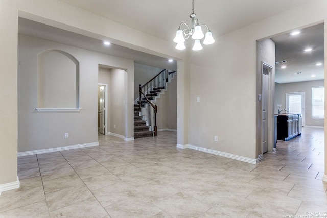 empty room featuring stairway, recessed lighting, baseboards, and an inviting chandelier