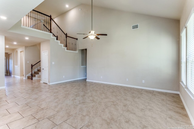 unfurnished living room featuring visible vents, high vaulted ceiling, stairs, and a ceiling fan
