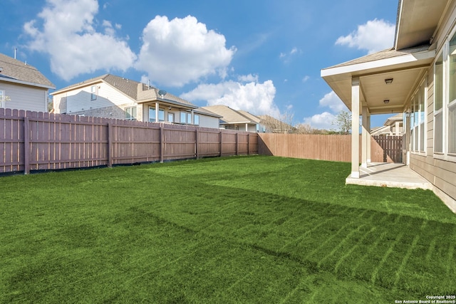 view of yard with a fenced backyard