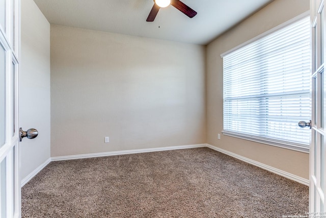 empty room with baseboards, carpet, and ceiling fan