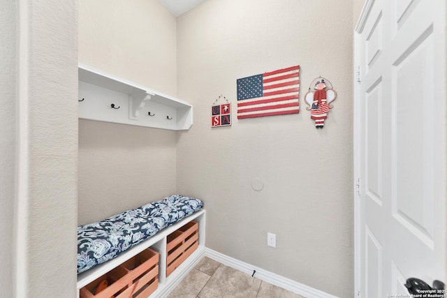 mudroom with light tile patterned floors and baseboards