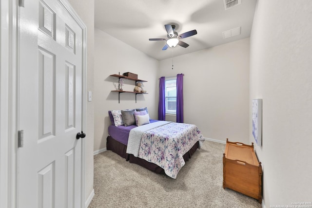 carpeted bedroom featuring visible vents, baseboards, and a ceiling fan