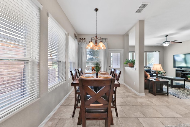 dining space with visible vents, baseboards, light tile patterned flooring, and ceiling fan with notable chandelier