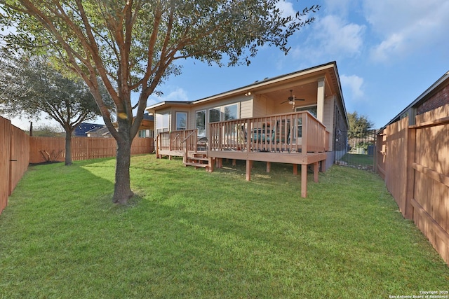 rear view of property with a wooden deck, a yard, a fenced backyard, and a ceiling fan