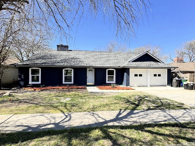 view of front of property with a garage, driveway, a front lawn, and a chimney